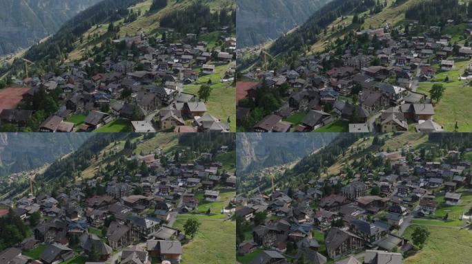 在Lauterbrunnen，悬崖和山脉之上的高山小镇Murren的空中无人机视图