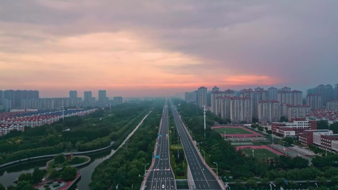 航拍清晨城市道路楼房朝霞天津武清绿化树木