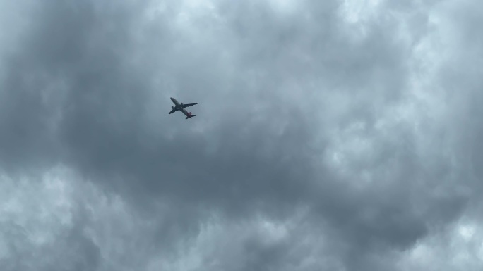 飞机飞过乌云密布的天空