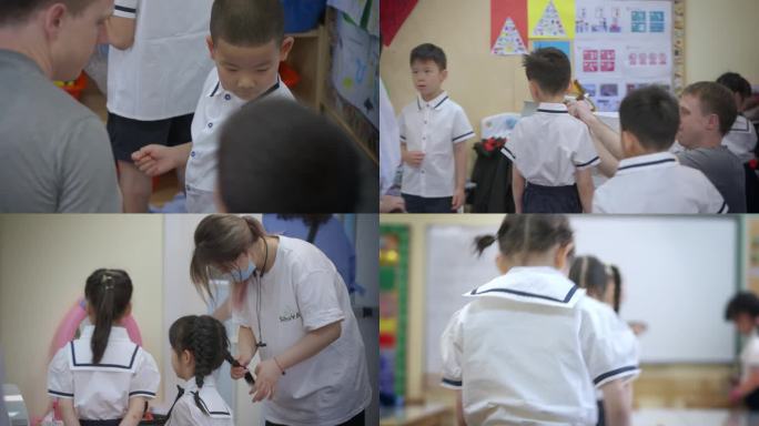 老师帮小朋友穿衣服 幼儿园外教