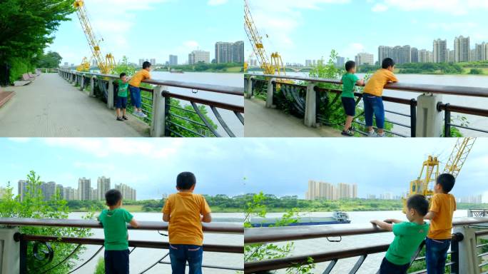 两个小孩在江边爬栏杆看风景