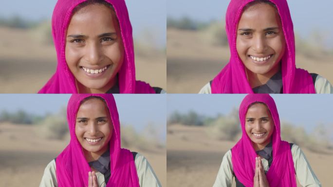 合十礼!印度沙漠上快乐的印度女孩的肖像