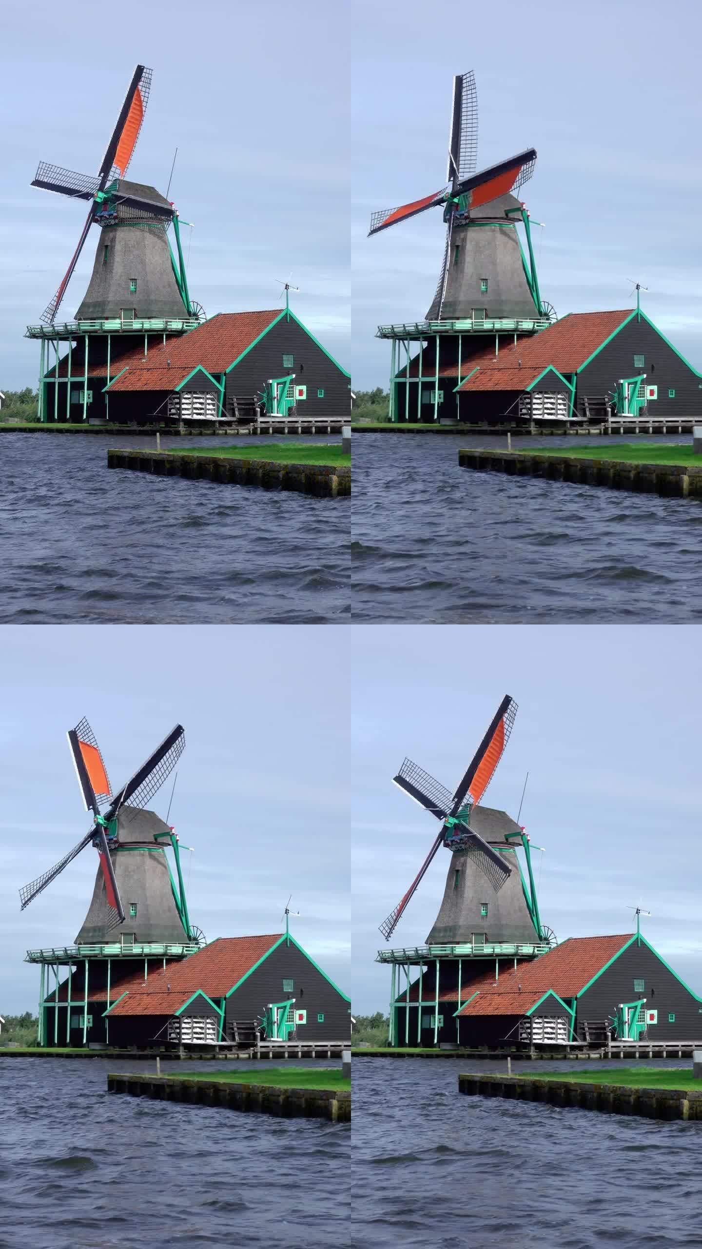 荷兰运河岸边的老式风车。垂直视频