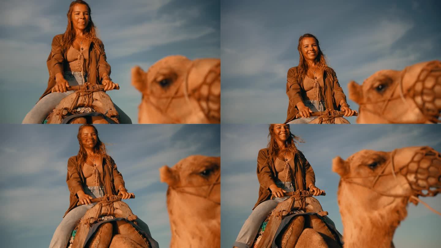 在多云的天空下骑骆驼的女游客