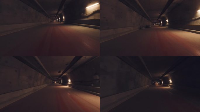无人机飞行第一人称视角飞行通过一个黑暗的隧道与道路