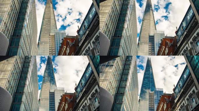 低角度拍摄的高耸的公司大楼摩天大楼，云层在高耸的建筑和玻璃建筑中反射，英国伦敦