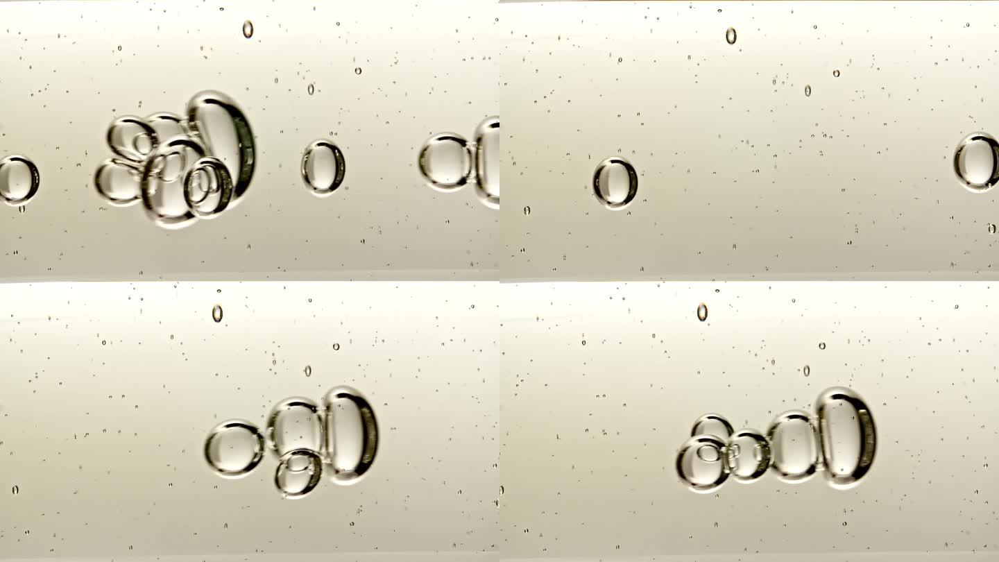 透明化妆品凝胶流体与分子气泡和油流动在玻璃管与透明液体在白色背景。微距镜头。生产特写。缓慢的运动。
