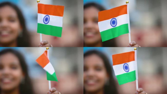 独立日，快乐的印度妇女手持印度国旗的画像。