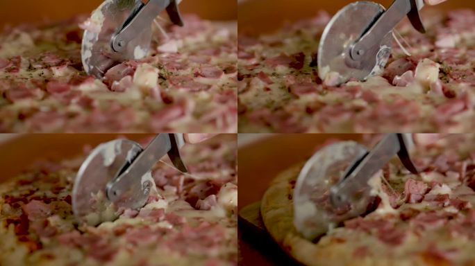 用滚刀慢动作切披萨。披萨饼切片的近距离微距拍摄。一个人用切披萨刀把披萨切成多片。快餐不健康的营养。