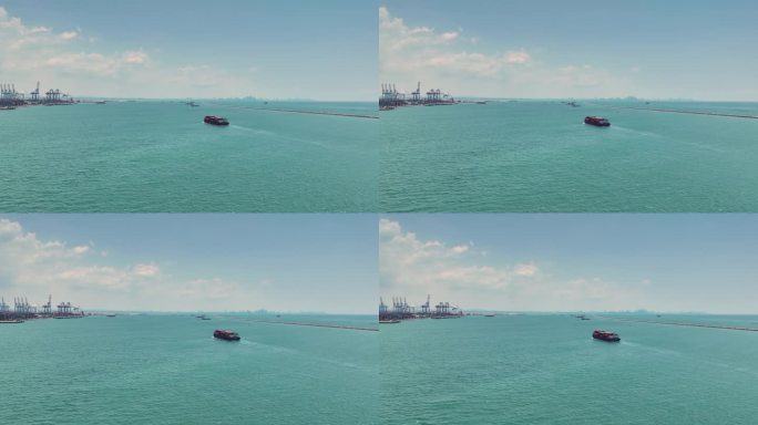 集装箱船在码头吊桥上进行远洋进出口业务。
