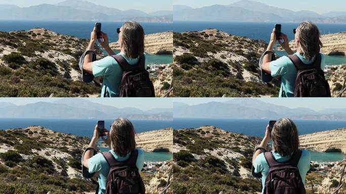 白发苍苍的运动员背着背包站在山上用手机拍视频，希腊，克里特岛，马塔拉
