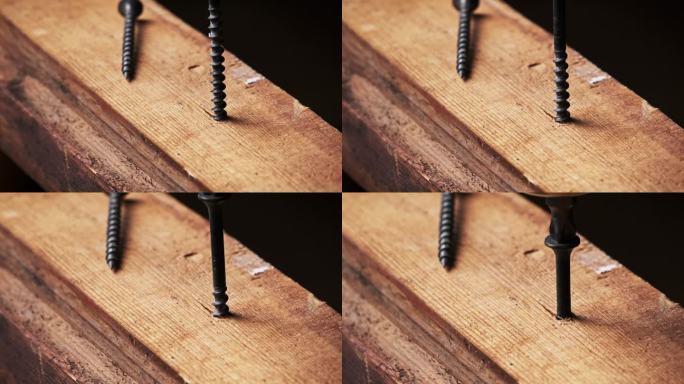 用螺丝刀将螺丝固定在木板上，特写