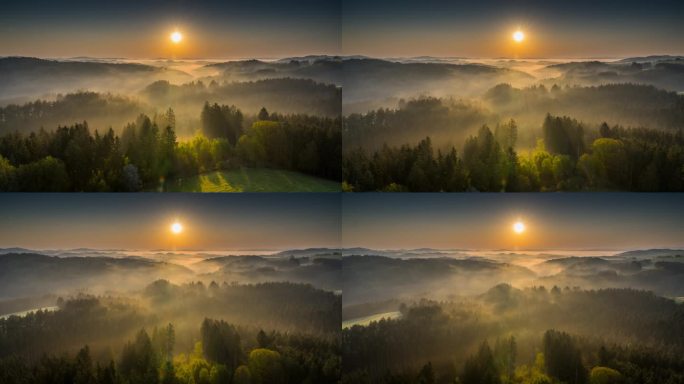 雾蒙蒙的山脉景观在日出