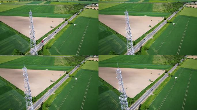 鸟瞰图:位于乡村公路附近的蜂窝天线与过往的车辆。传送数字信号的电信塔。无线通信，数据传输，5G。