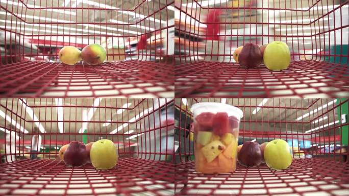 在超市里，买家把新鲜切碎的水果放进红色的购物车里。为全家人提供健康适当的营养