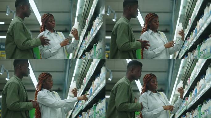 站在超市购物车旁挑选奶制品的非裔美国男女。
