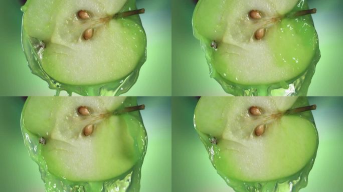 从半个苹果流出的青苹果汁，微距慢镜头