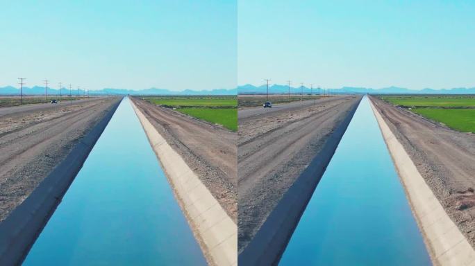 一个垂直无人机拍摄的灌溉清澈运河在南加州在一个晴朗的日子