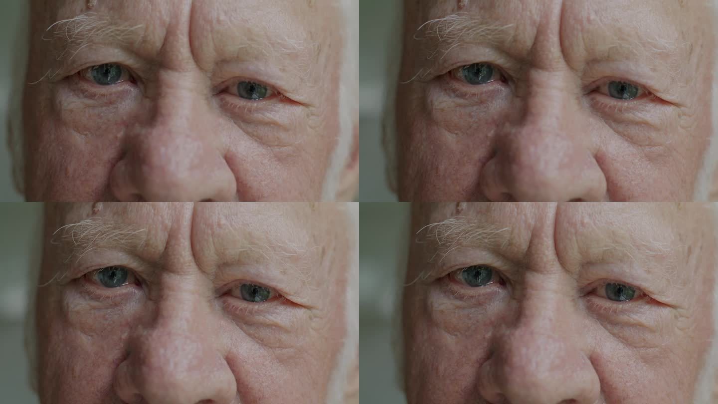 一个退休老人的特写慢镜头，他看着镜头，眼神忧伤，在家里感到孤独