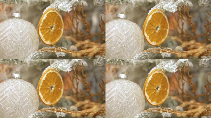 冷杉树枝上的圣诞装饰。圣诞树上的玩具。圣诞树上的橘子片。冬日喜庆的装饰，闪烁着闪亮的彩灯。许多五颜六