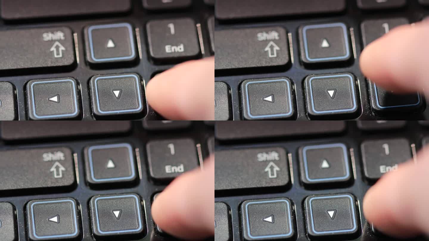 手指按下笔记本电脑键盘上的箭头键