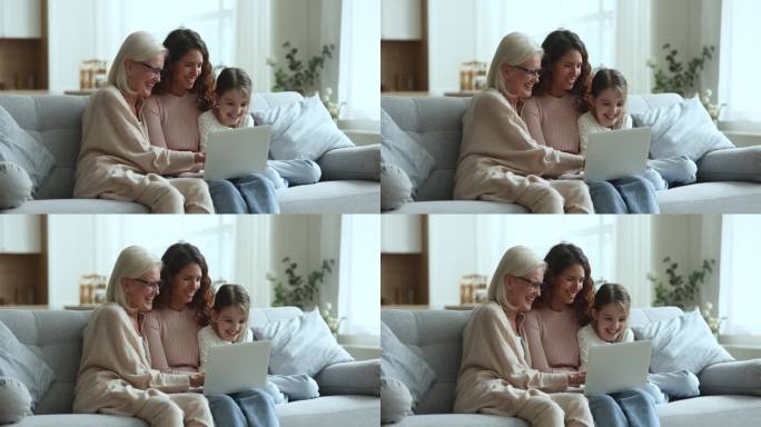 小女孩与妈妈和奶奶用笔记本电脑消遣