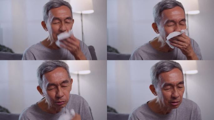 患有过敏症的亚洲老人打喷嚏。