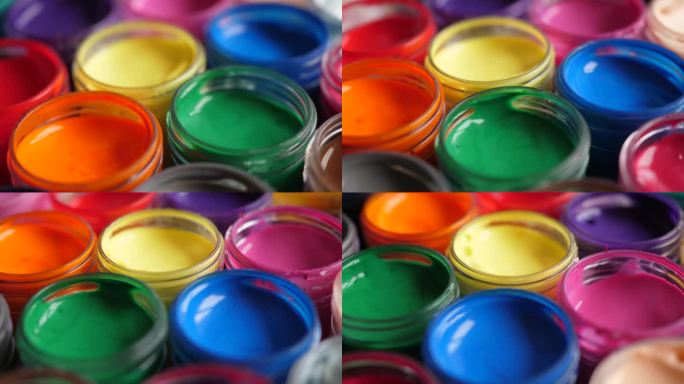 设置水粉颜料在罐子明亮的颜色接近。旋转套多色水粉上的塑料罐。旋转多色背景。多色涂料的背景。创意绘画艺