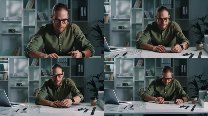 一位和蔼可亲的建筑师戴着眼镜，在纸上画着线条。