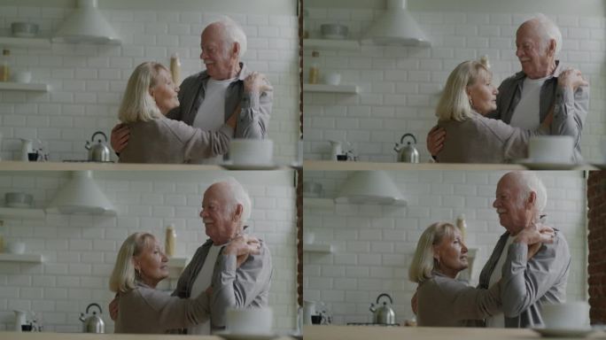 慢动作，快乐的老年夫妇跳舞，微笑，大笑，享受浪漫的关系在家里