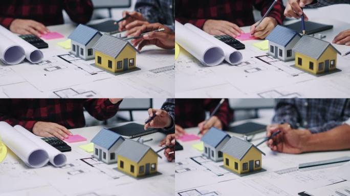 工程师咨询团队为客户设计建筑图纸和模型，在办公室工作。
