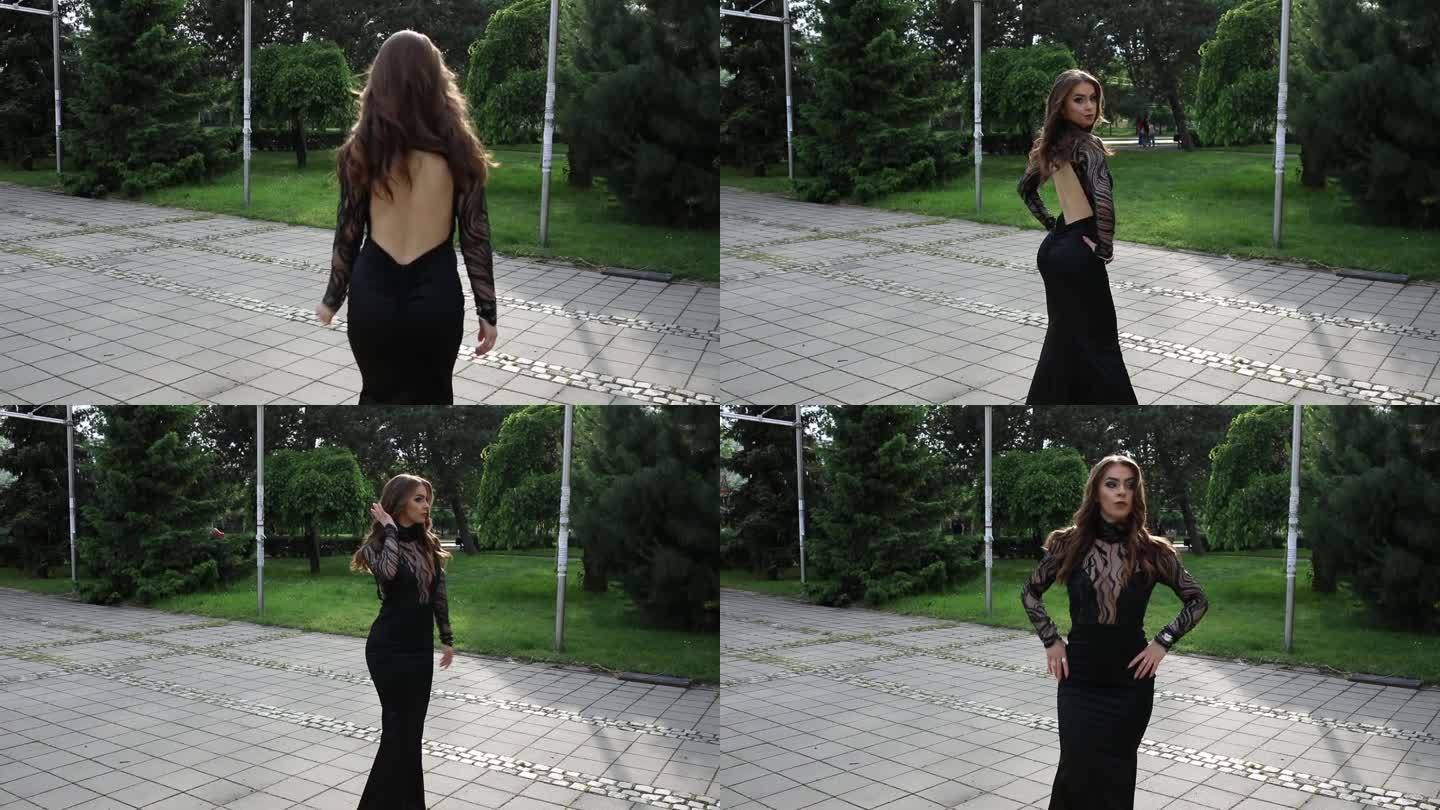 一位穿着黑色长裙、露背的优雅年轻女子正从镜头前走开