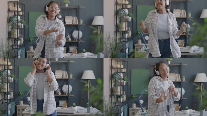 非裔美国妇女戴着耳机独自在家跳舞的慢动作肖像