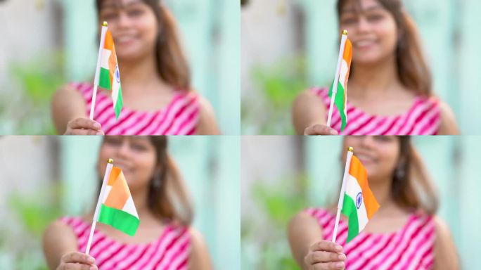 独立日，快乐的印度妇女手持印度国旗的画像。