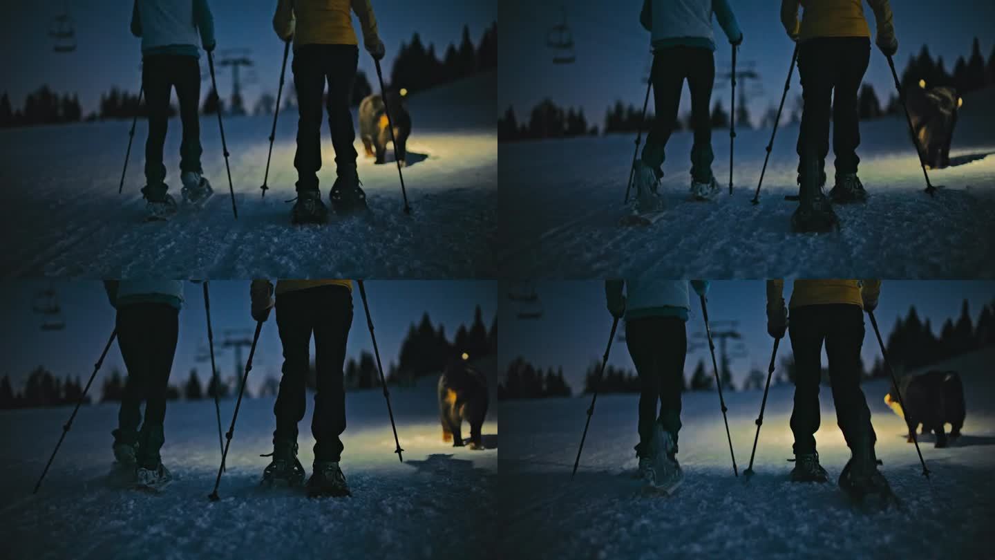 黄昏时分，人们在滑雪胜地的雪坡上穿雪鞋