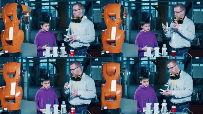 一个男孩在一个现代化的实验室里和老师一起学习机器人技术