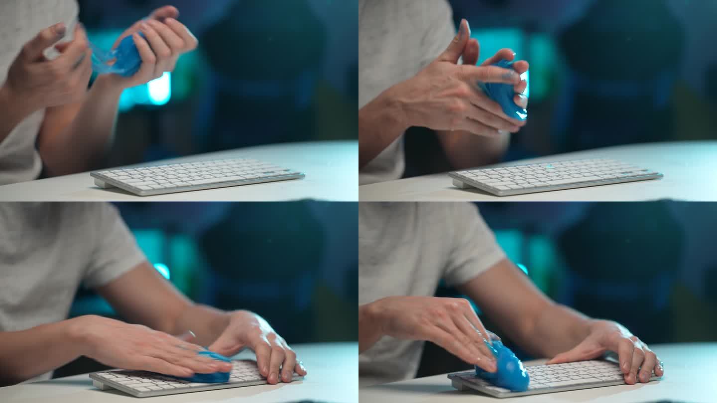 近距离的双手无法识别的清洁清除灰尘从肮脏的白色无线PC键盘使用蓝色粘稠的吸收凝胶。一般清理的概念