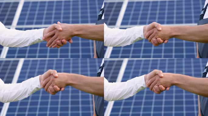 两位工程师在讨论完光伏太阳能板的背景后，老板和下属正在握手