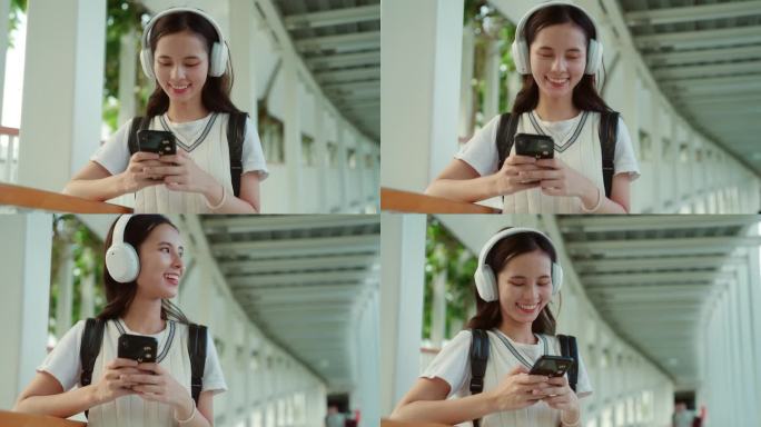微笑的女人用智能手机和耳机拥抱大自然的旋律