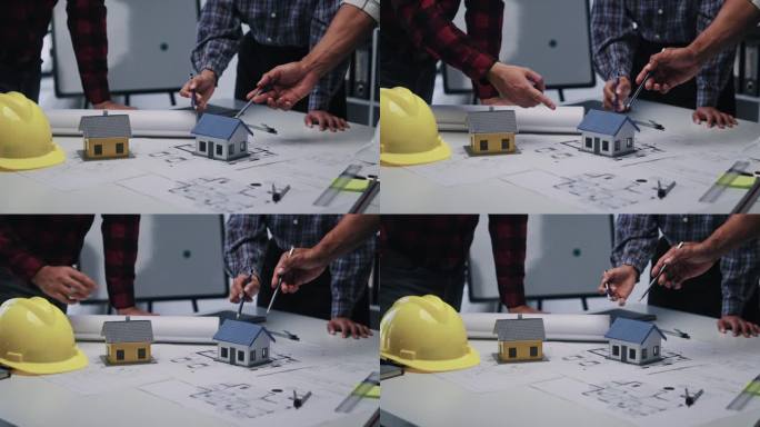 工程师咨询团队为客户设计建筑图纸和模型，在办公室工作。