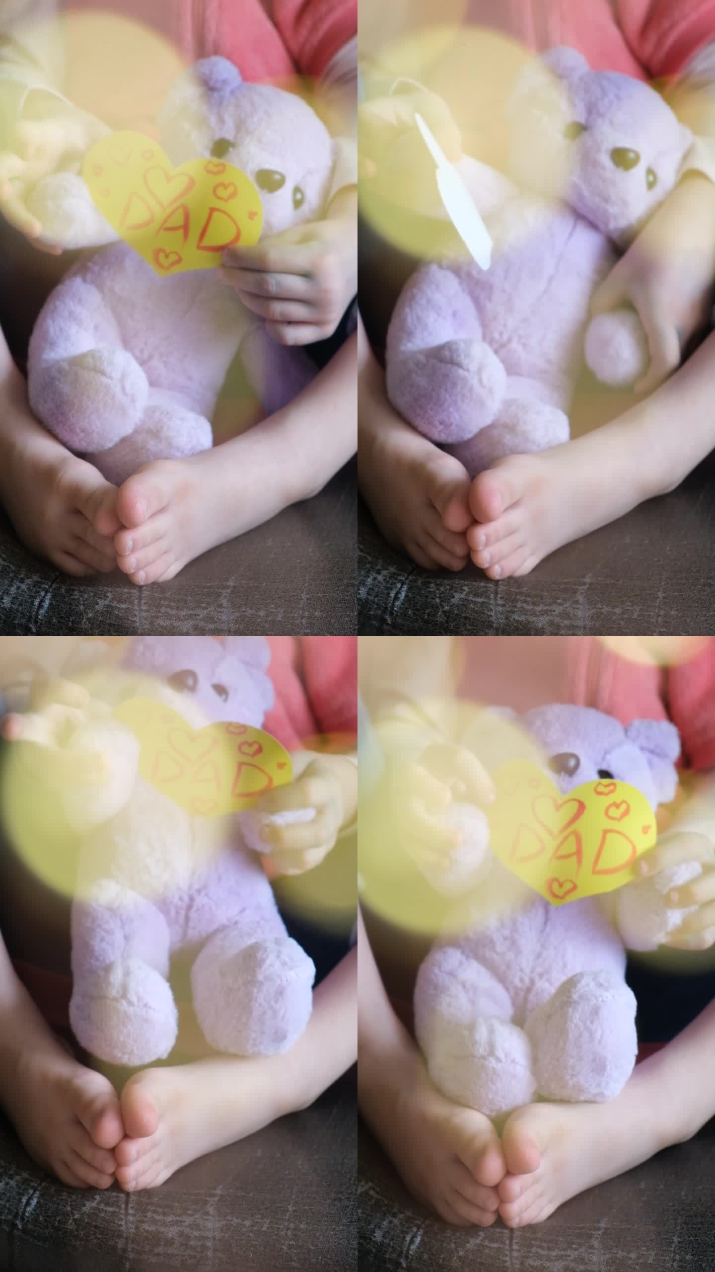 小女孩手持可爱的泰迪熊玩具和手工制作的心形父亲节贺卡。爸爸的文本