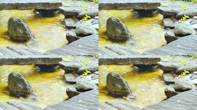 雨季古镇石头水池滴水实拍视频