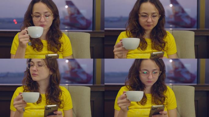 游客在机场航站楼喝咖啡，使用智能手机