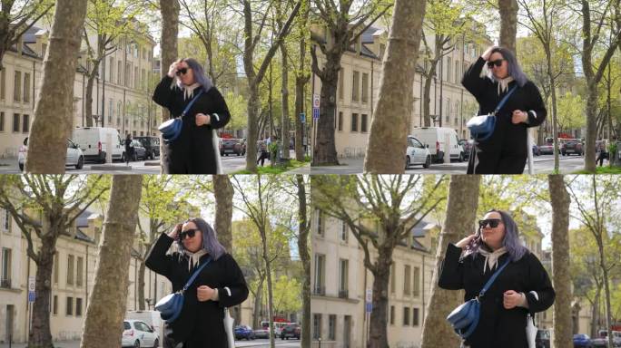 穿着大衣的时尚年轻女子在阳光明媚的春日走在巴黎老街上。春天，戴着墨镜的时尚女性走在巴黎街头