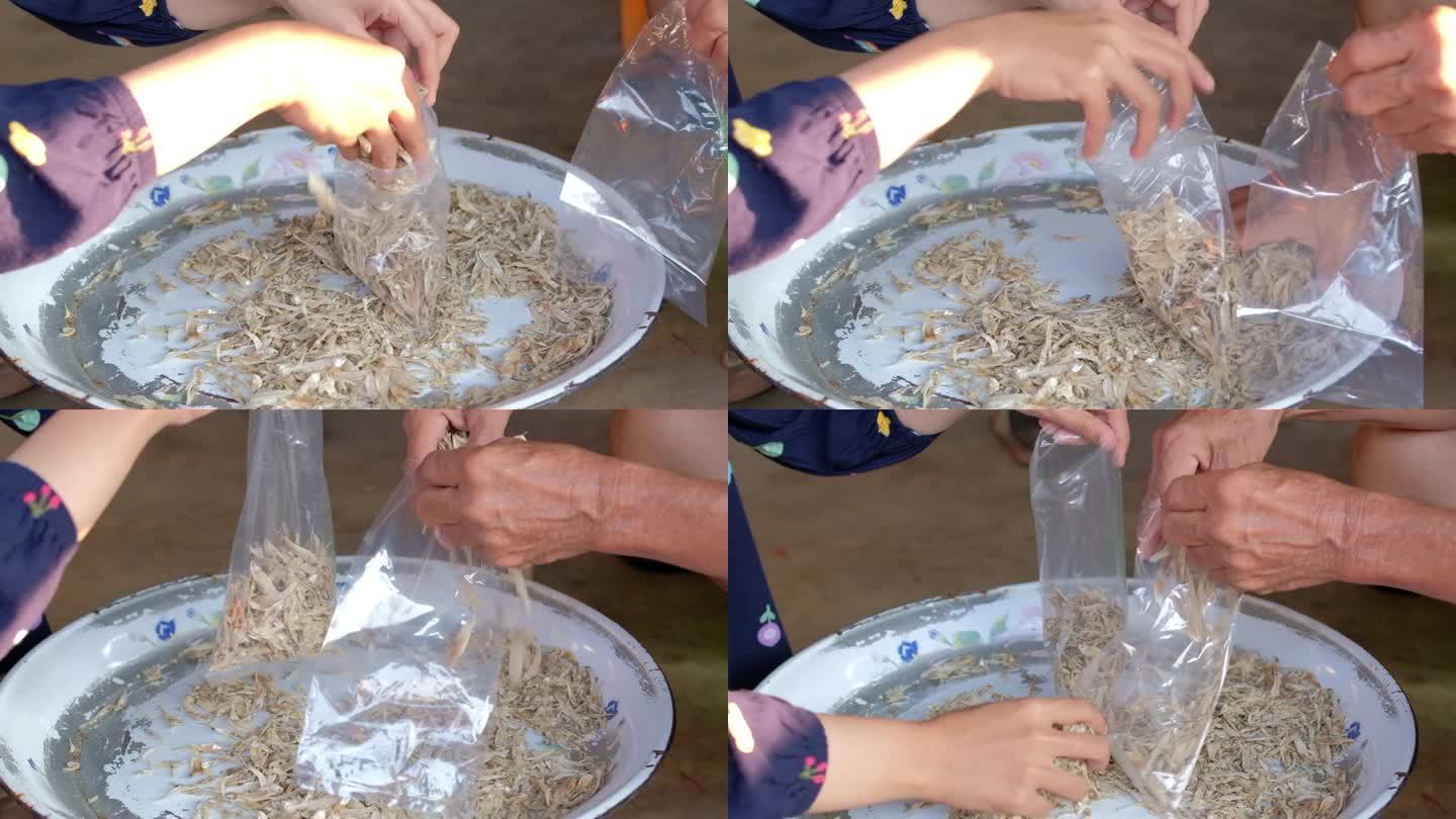 工人们将传统的腌制凤尾鱼打包