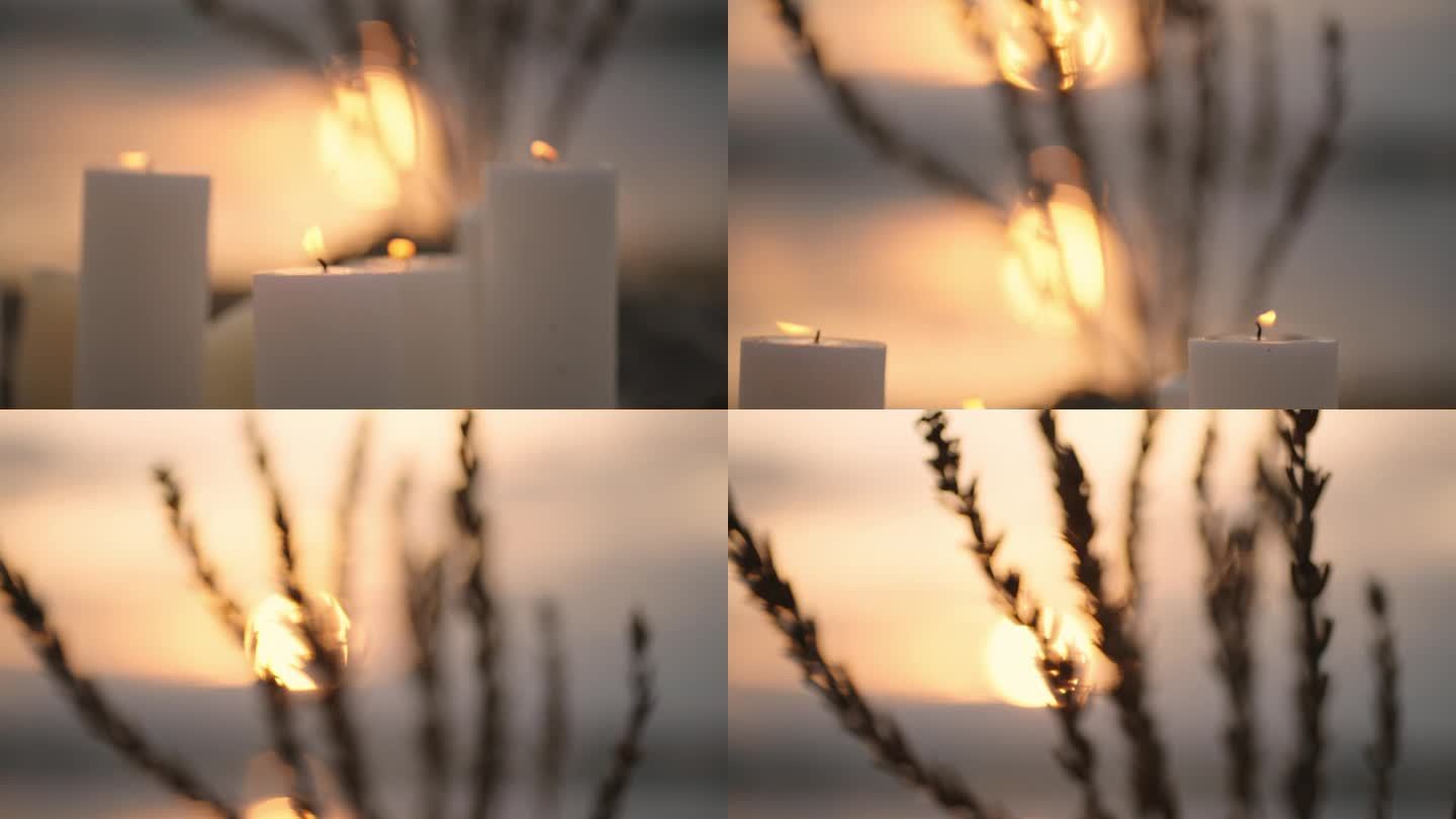 夏日湖岸浪漫的夕阳，前景是燃烧的蜡烛和干花