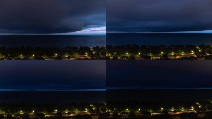 一团乌云在密歇根湖上空翻滚，暴风雨的时间流逝，天气锋面覆盖了夜晚的天空，交通信号灯在前景中划过湖岸大
