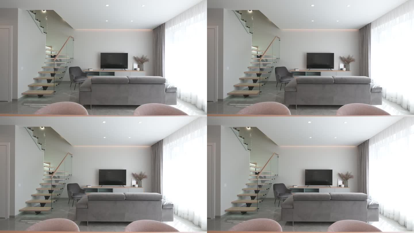 宽敞明亮的房间，斯堪的纳维亚风格，时尚的木制楼梯与玻璃元素和灰色沙发