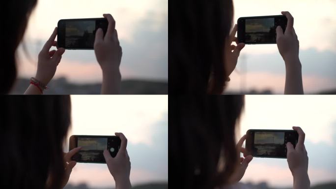 女性青年山顶用手机拍照拍风景拍摄摄影照相