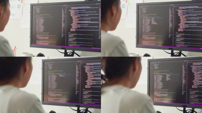 特写年轻的亚洲女孩，IT开发程序员，在键盘上打字，编码，编程，在电脑显示器和笔记本电脑上修改数据库代
